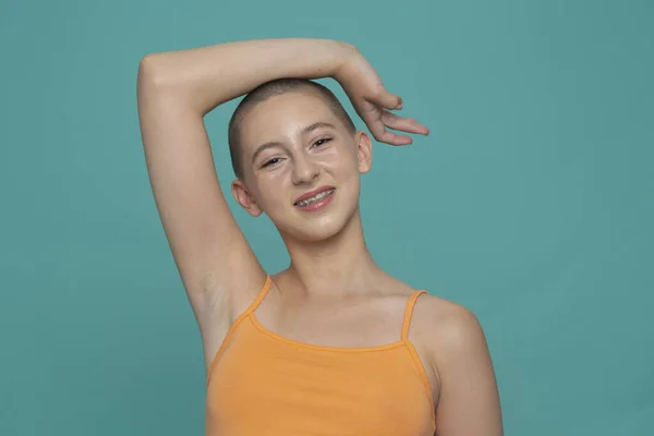 Turuncu bluzlu gülümseyen kızın stüdyo portresi