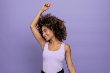 Smiling brunette with arm raised