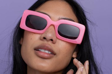 Portrait of woman wearing pink sunglasses