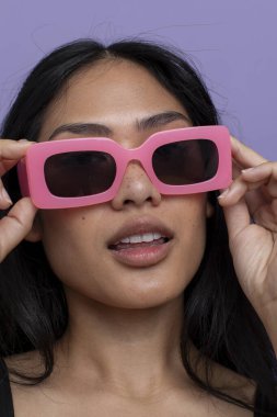 Portrait of woman wearing pink sunglasses