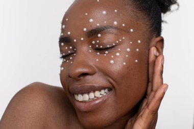 Smiling young woman wearing pearl freckles