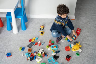 Boy (2-3) playing with toy blocks at home