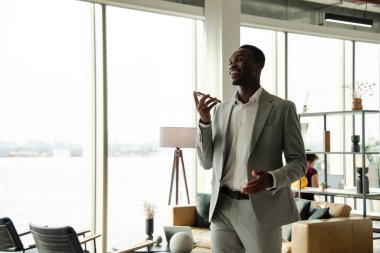 Young businessman using smart phone in office