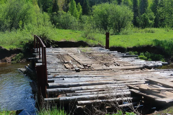 destroyed bridge over the river in the village
