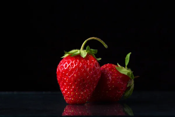Zwei Erdbeeren Auf Schwarzem Hintergrund Eine Erdbeere Steht Die Andere — Stockfoto