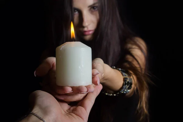 Girl Burning Candles Brunette Black Background Hands White Candle Another — Stock Photo, Image