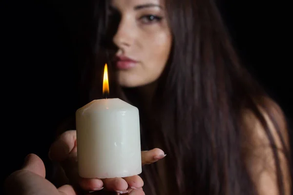 Girl Burning Candles Brunette Black Background Hands White Candle Another — Stock Photo, Image