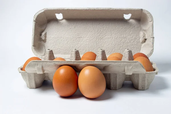 Eggs on a white background. Chicken eggs in a paper box. Two eggs lie side by side