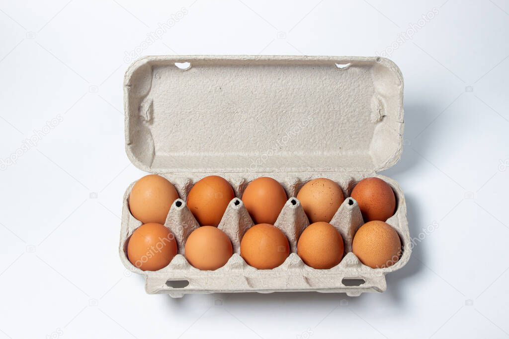 Eggs on a white background. Chicken eggs in a paper box