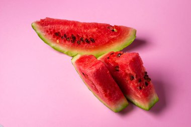 Pembe arka planda karpuz. Bir dilim karpuz kes. Olgun kırmızı karpuz