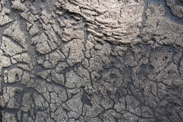 Old felt roofing tar fragment as an abstract background