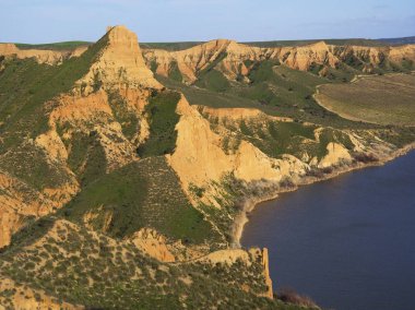 Gün batımında güneşle aydınlatılan yeşil dağlar