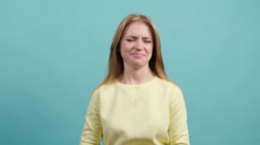 Tiksinti gösteren beyaz bir kız, kötü kokudan kaçmak için burnunu çimdikliyor..