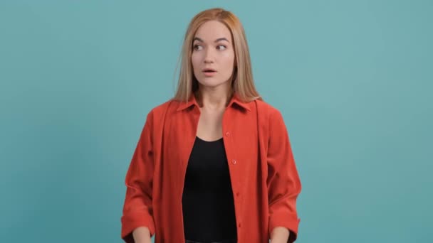 Femme confus tenant la main sur la tête sur fond studio turquoise. — Video