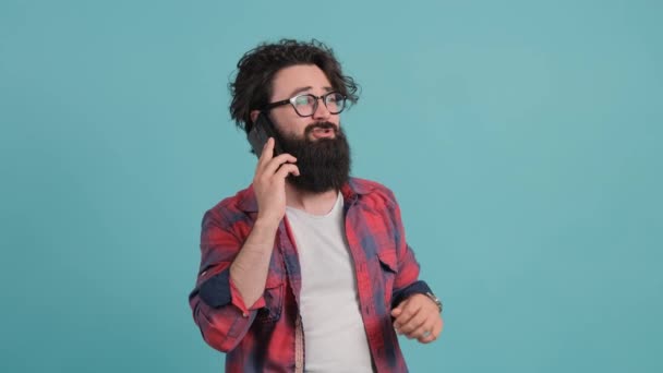 Portrait of happy brunette bearded man having a pleasant mobile conversation. — Stock Video