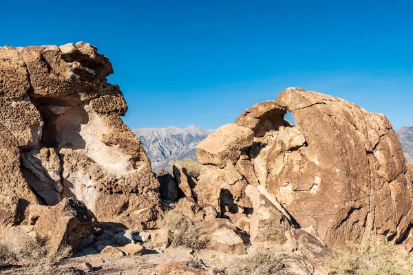 desert rock formations and distant mountains in Owens Valley California USA