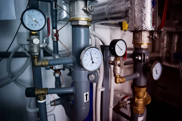 Close up of pipes and termometeres of the heating system. Industrial concept. Heating of the building.