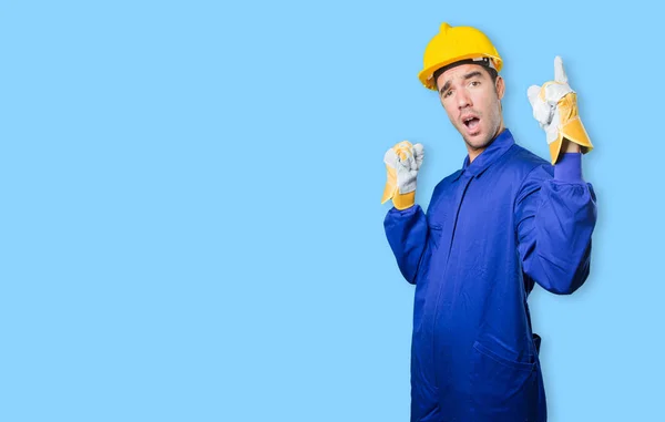 Happy workman with number one gesture on white background