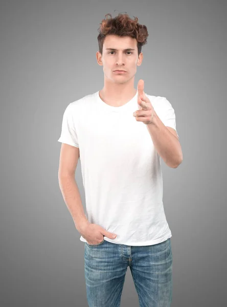 Confident young guy pointing with his hand