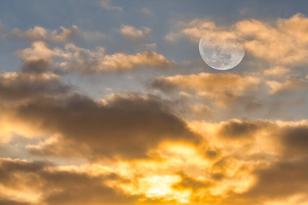 The Moon is Rising in the Sky Surrounded by Vivid Colorful Clouds