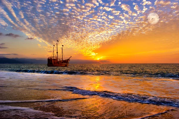 stock image A Pirate Boat is Out at Sea As Birds Fly By a Full Moon Rising in the Sky