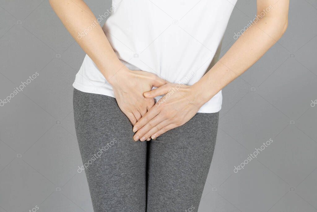 crop image of hand on the crotch area,Penis pain.Health-care,urinary,infection, incontinence,bladder,dysmenorrhea concept on gray background