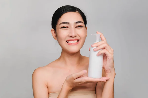 Beauty concept,Young beautiful asian woman with clean,fresh and bright skin,Happiness and cheerful with positive emotional Holding skin toner bottlea and cotton swab to clean the face,Facial treatment