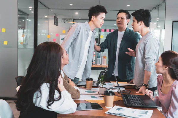 An argument arose between two men during the meeting with the boss resisting in group brainstorm at office.Businesspeople discussing with paperwork for business plan,Corporate of modern colleague
