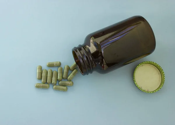 Chlorella in capsules super food. vegetable dietary Supplement Chlorella.capsules are poured out of the bottle.