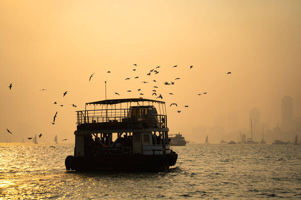 MUMBAI, MAHARASHTRA, INDIA, December 9, 2024: Tourrists travel by ferry boats from Gateway of India to Elephanta Caves. 