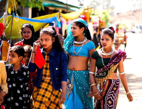 ALIRAJPUR, MADHYA PRADESH, INDIA, 15 MARCH 2022 : Tribal women gathered together at the Bhagoria tribal festival, In this festival young boys and girls choosing their partners before marriage