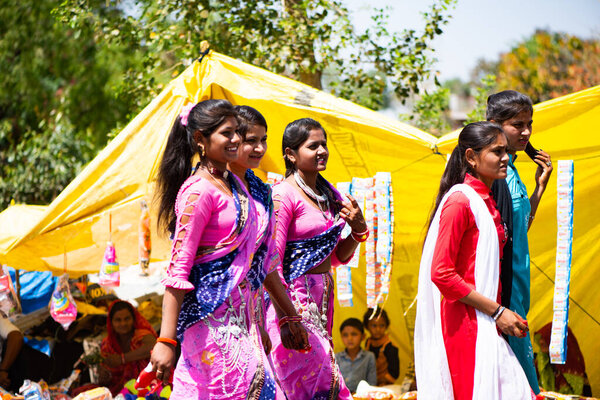 ALIRAJPUR, MADHYA PRADESH, INDIA, 15 MARCH 2022 : Tribal women gathered together at the Bhagoria tribal festival, In this festival young boys and girls choosing their partners before marriage
