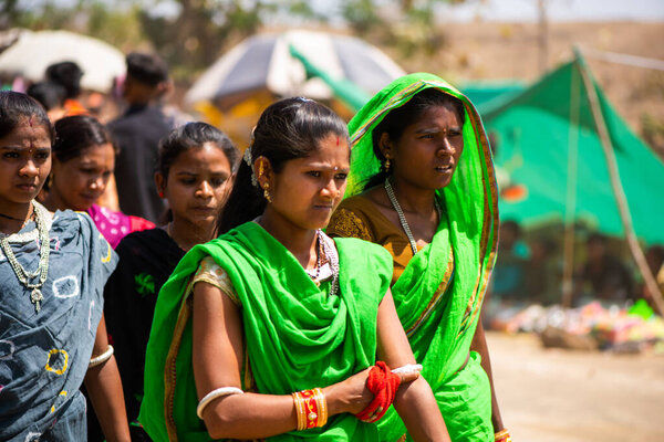 ALIRAJPUR, MADHYA PRADESH, INDIA, 15 MARCH 2022 : Tribal women gathered together at the Bhagoria tribal festival, In this festival young boys and girls choosing their partners before marriage