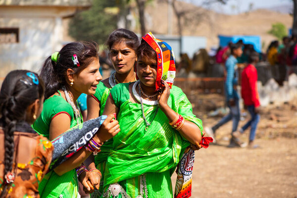 ALIRAJPUR, MADHYA PRADESH, INDIA, 15 MARCH 2022 : Tribal women gathered together at the Bhagoria tribal festival, In this festival young boys and girls choosing their partners before marriage