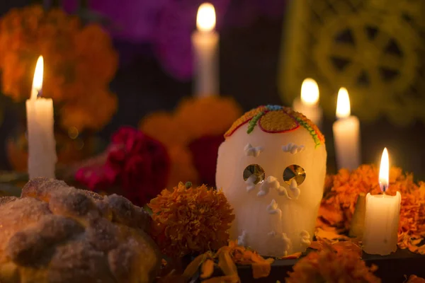 Sugar skull with candles, bread and flowers decoration for the day of the dead altar mexican tradition