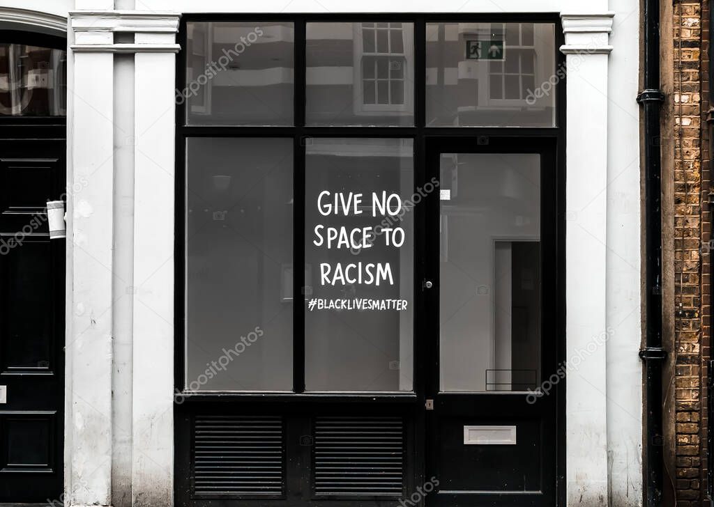 View of Racism & Black Lives Matter Sign on Shop Window in London, UK