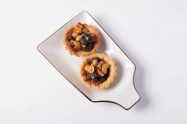 Beyaz arka planda kurabiye, fındık ve kuru üzüm