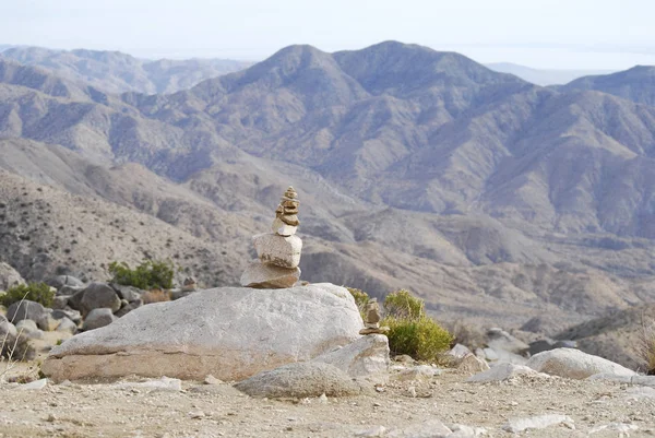 Mountain dry landscape with a stone cairn