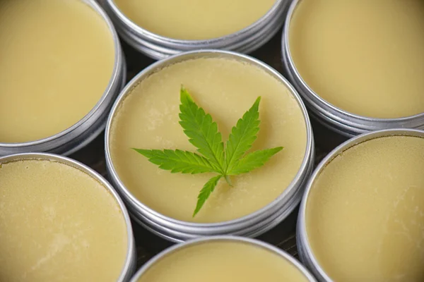 Cannabis hemp cream background with marijuana leaf - cannabis topicals concept