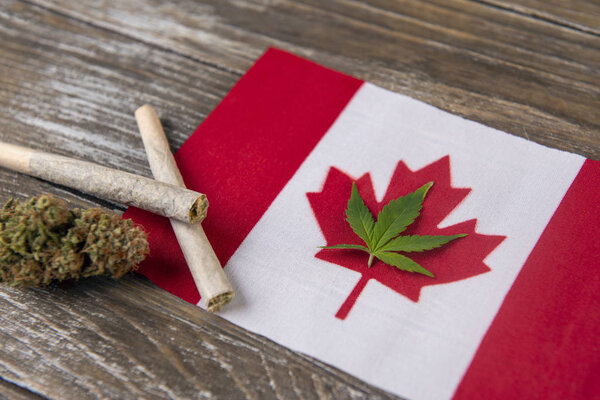 Canadian flag with assorted marijuana products - medical marijuana concept background