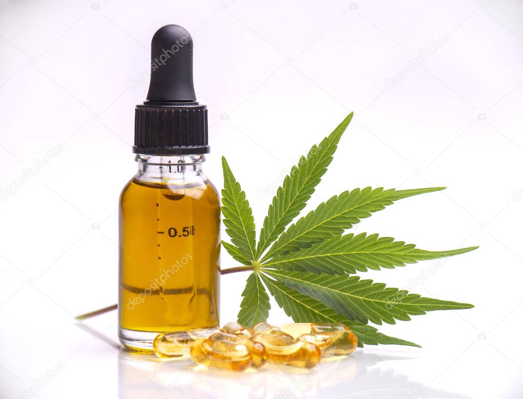 Assorted medical cannabis products with leaf, capsules and CBD oil isolated over white background