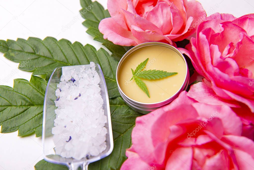 Cannabis infused beauty products with roses and marijuana leaves