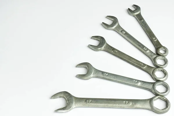 Five different wrenches lie on the right on a white background Royalty Free Stock Images