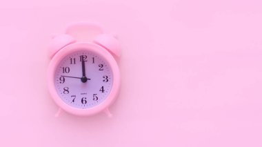 Pembe arka planda pembe alarmlı saat. Kopyalanacak yer. Asgari konsept.
