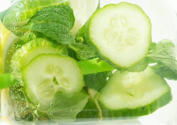 Limon dilimi, limon, salatalık. Köpüklü karbonatlı suya atlamak, ferahlatıcı bir meyve suyu. Geçmişi. Sağlıklı beslenme kavramı.