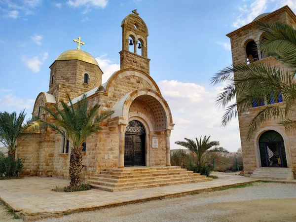 View of St. John the Baptist Greek Orthodox Church, located at the site of the baptism of Jesus Christ on the Jordan River. Blue sky with some clouds.