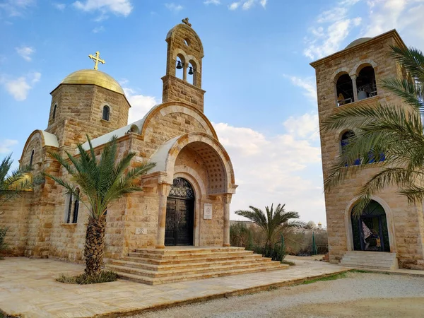 View of St. John the Baptist Greek Orthodox Church, located at the site of the baptism of Jesus Christ on the Jordan River. Blue sky with some clouds.