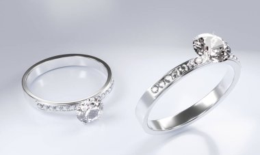 Platin altından yapılmış elmas yüzükler beyaz bir yüzeye yerleştirilmiş küçük elmaslarla süslenmiş. 3B Hazırlama