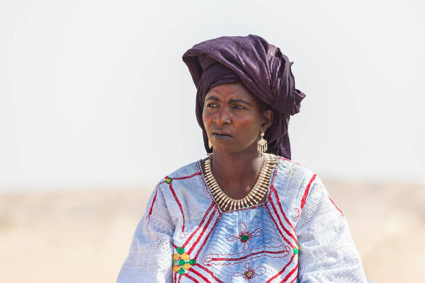 nomad woman in traditional turban Sahara desert