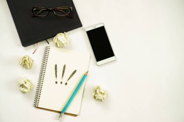 Yeni fikirler. Üç ünlem işaretli defter, kağıt toplar, akıllı telefon, dizüstü bilgisayar, kalem. Boşluğu kopyala